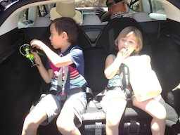 Kids seated in Tesla trunk